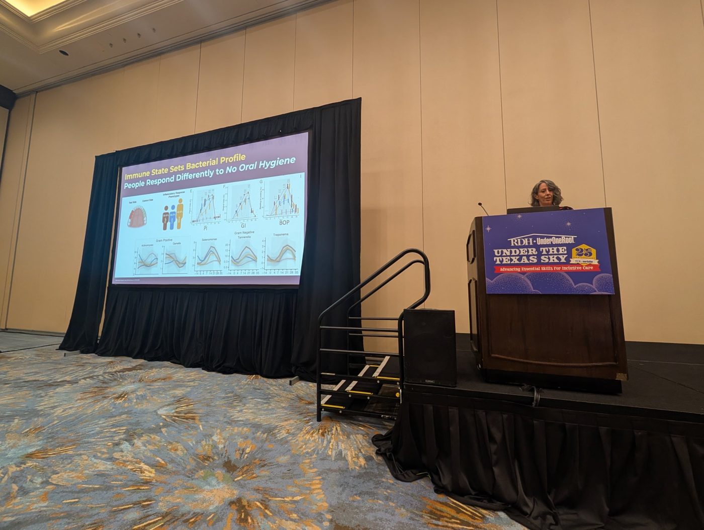Camille presenting at RDH Under One Roof Under the Texas Sky, with a slide titled Immune State Sets Bacterial Profile
